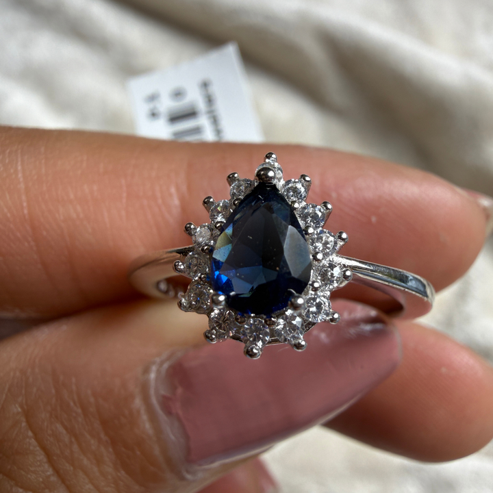 Blue pear gemstone and lab-grown diamond halo ring by Kiashaa Jewellery.