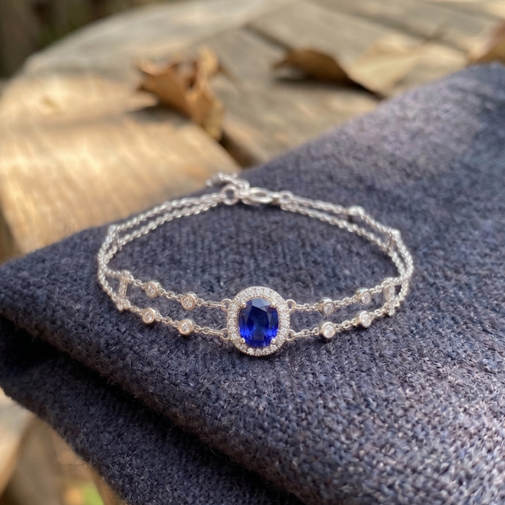 2 CT oval blue sapphire bracelet with diamond halo in yellow gold by Kiashaa Jewellery.