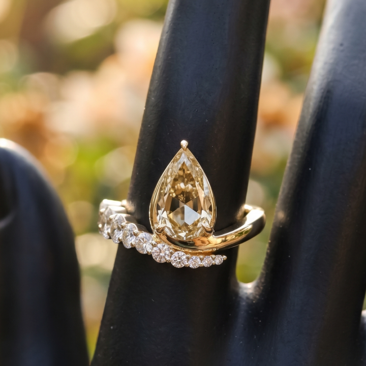 Aurelia 4.50 CTW pear diamond bypass ring by Kiashaa Jewellery featuring a 3 CT pear center diamond in polished yellow gold.