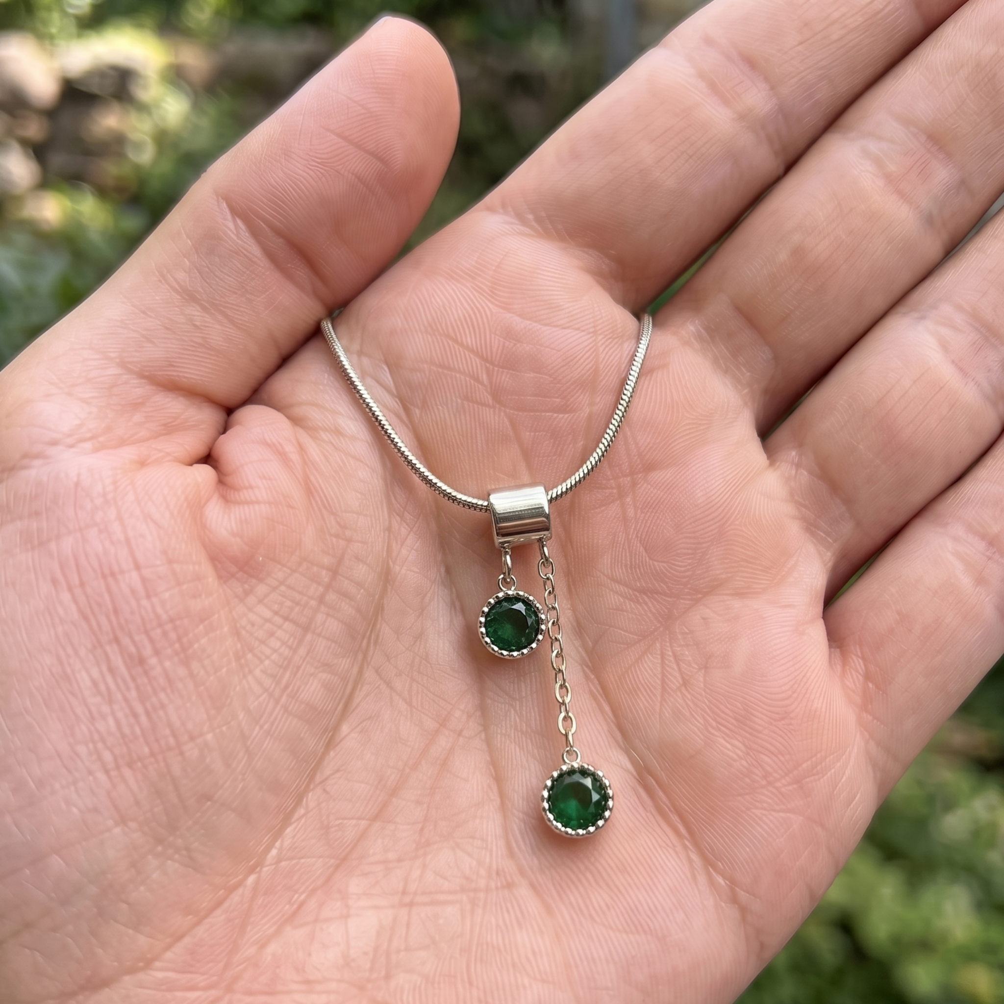  1.50 CTW green round gemstone drop necklace in polished yellow gold.