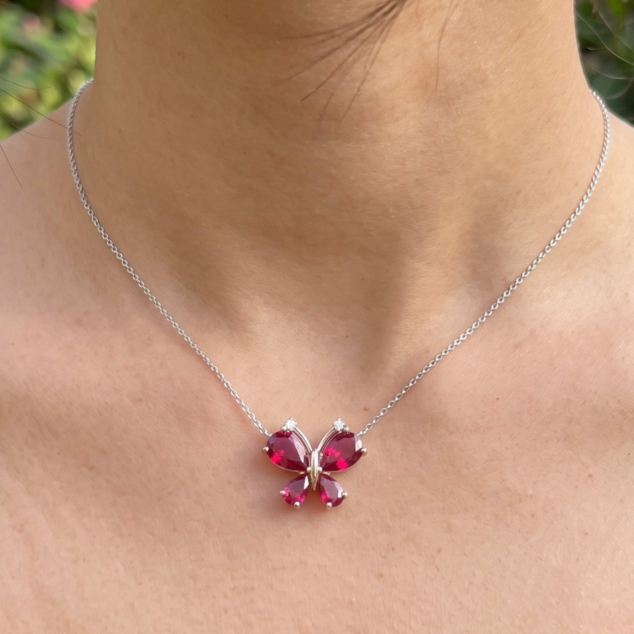 Red pear gemstone butterfly pendant necklace with lab-grown diamond accents by Kiashaa Jewellery.