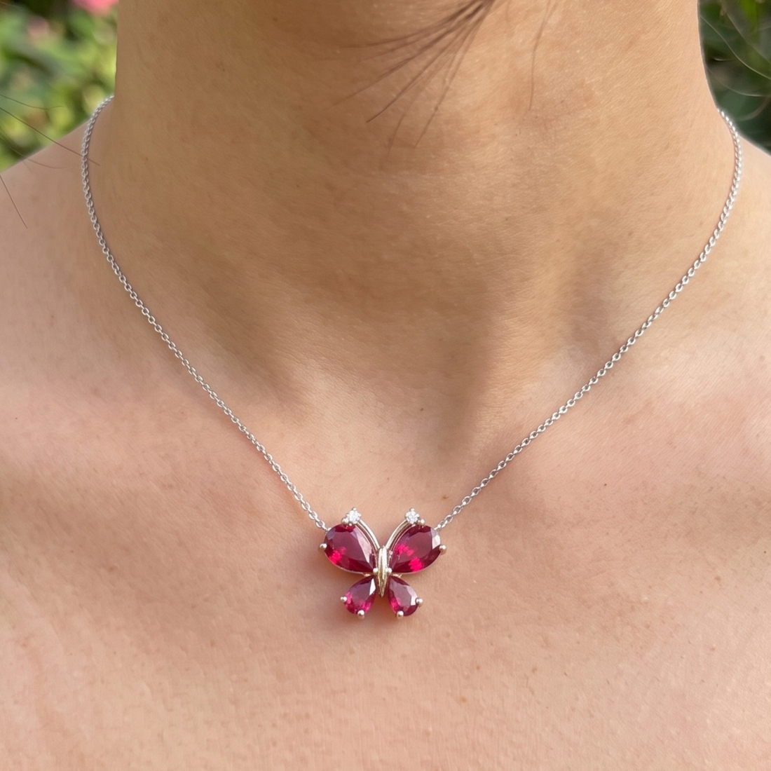 Red pear gemstone butterfly pendant necklace with lab-grown diamond accents by Kiashaa Jewellery.