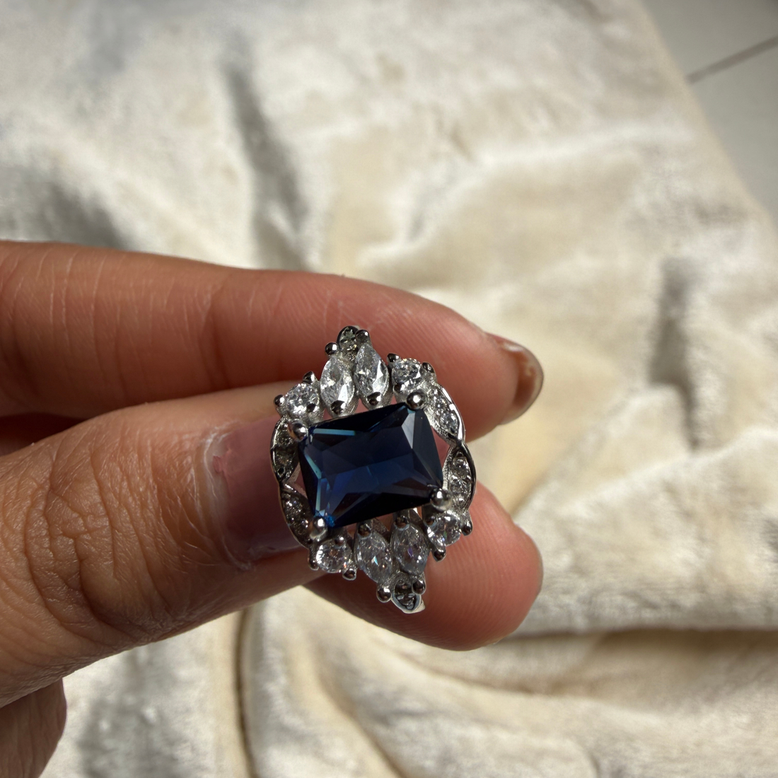 Blue emerald gemstone and lab-grown diamond halo ring by Kiashaa Jewellery.