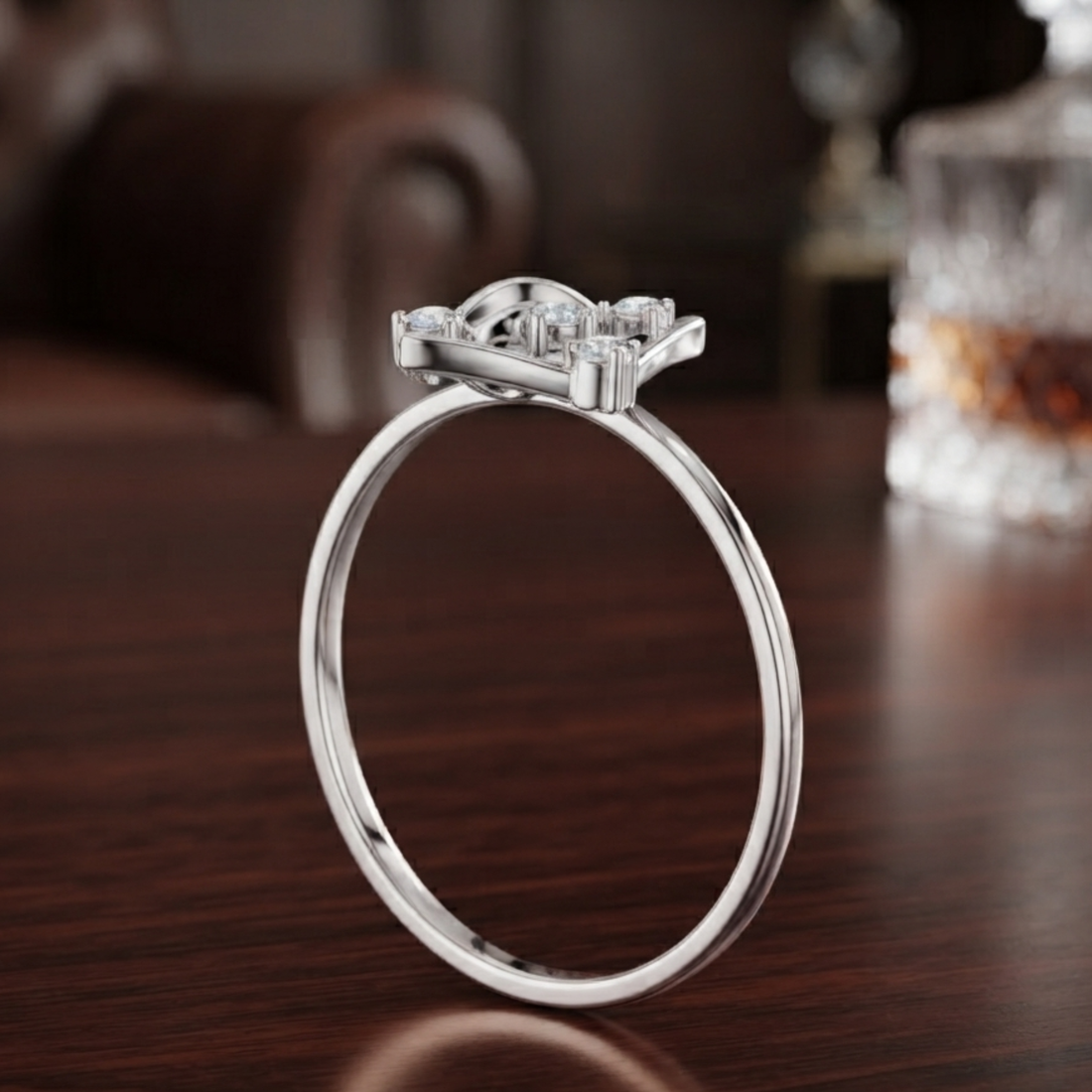 A silver-toned ring with a three-stone cluster setting, standing upright on a dark wooden table with a blurred background.