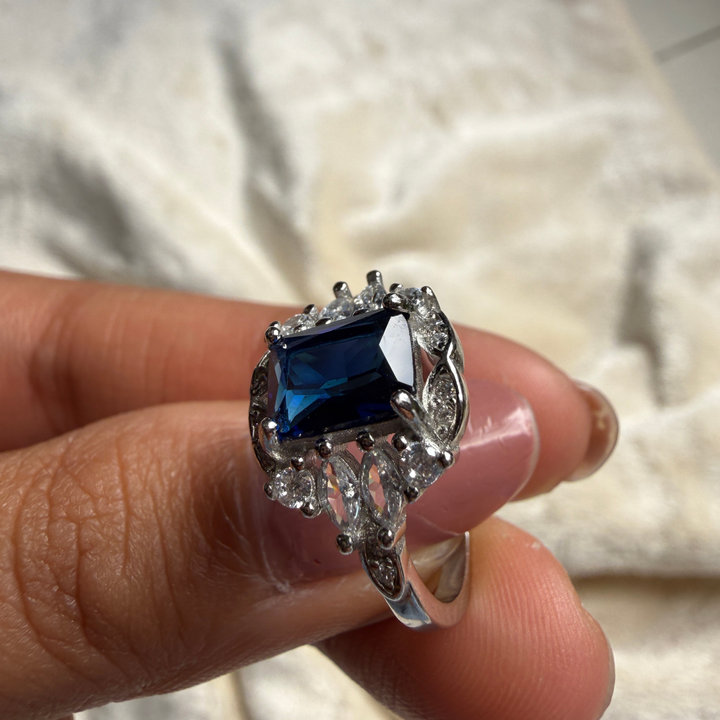 Blue emerald gemstone and lab-grown diamond halo ring by Kiashaa Jewellery.