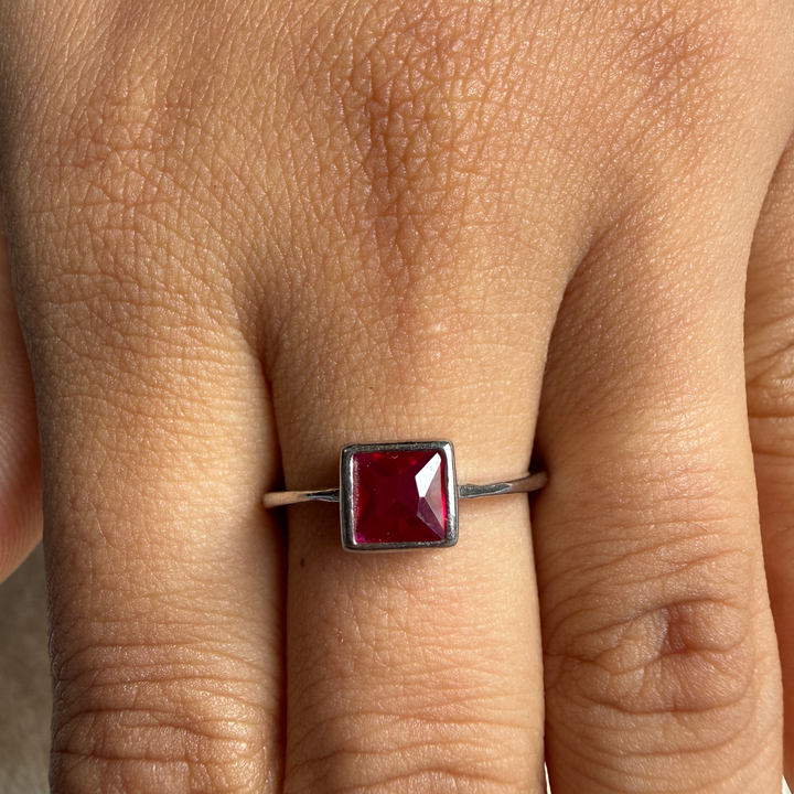 Red princess-cut gemstone solitaire ring in white gold by Kiashaa Jewellery.