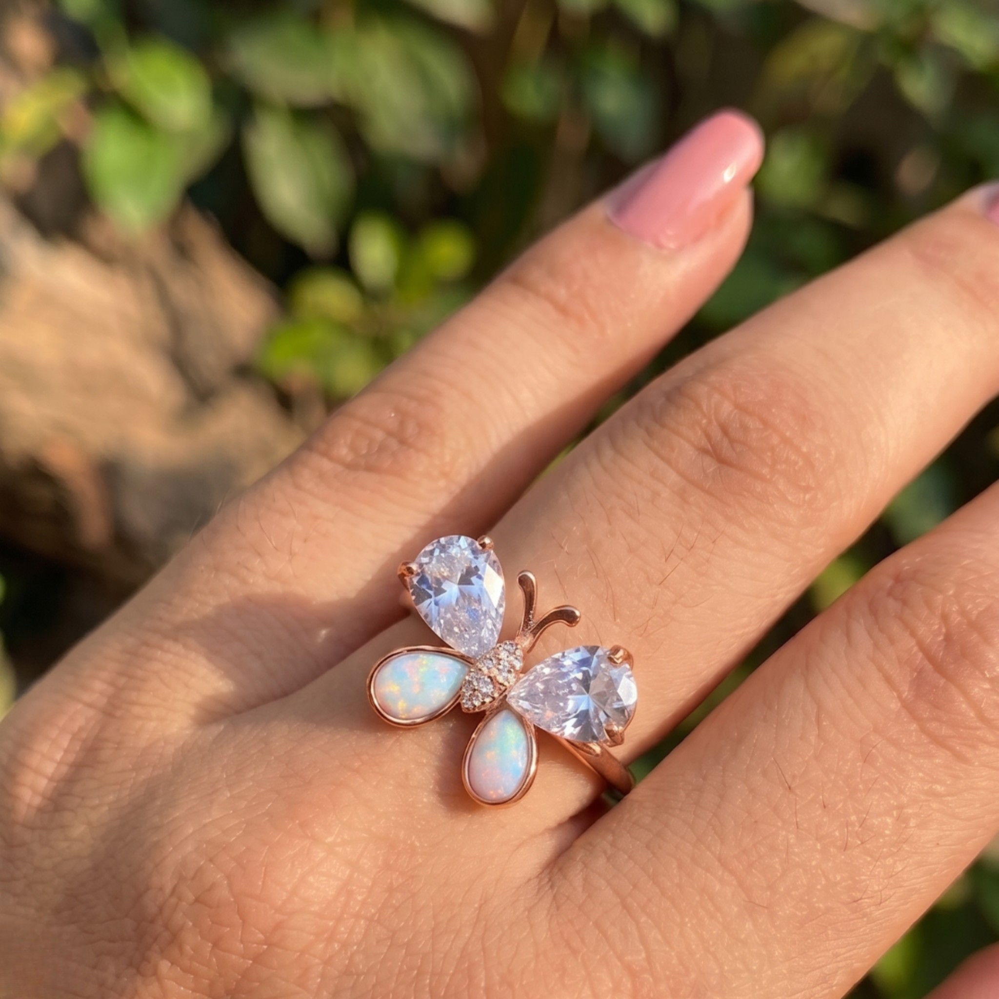 Nature-inspired butterfly ring featuring pear-shaped lab-grown diamonds and opal gemstones.