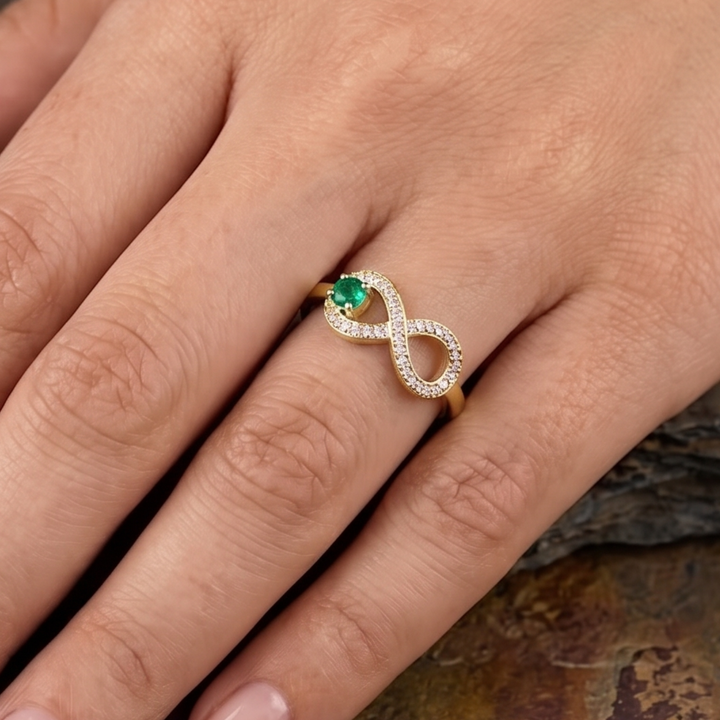 Green diamond infinity ring by Kiashaa Jewellery in polished yellow gold.