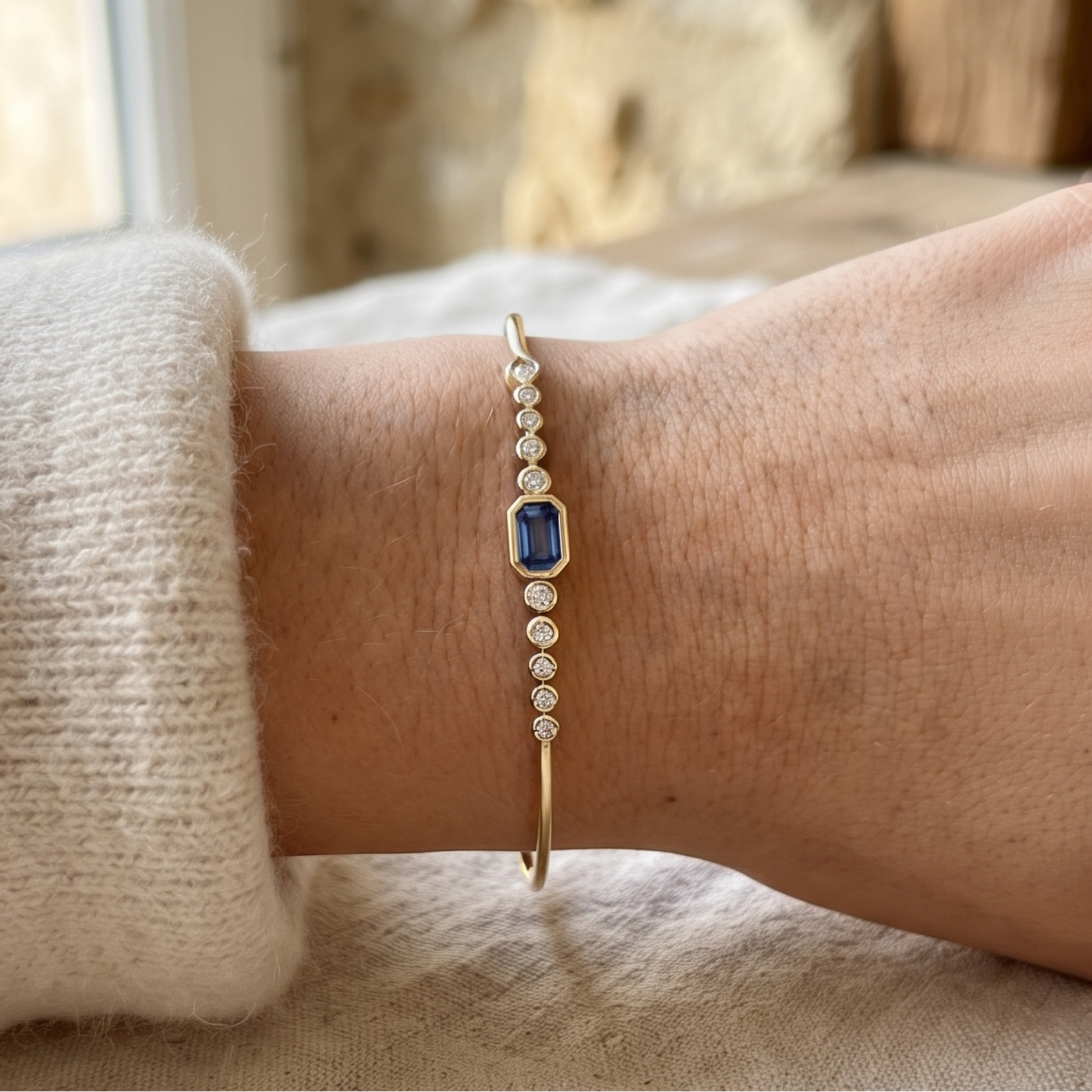 Kiashaa Jewellery 1.582 CTW blue emerald and round diamond bangle in polished yellow gold.