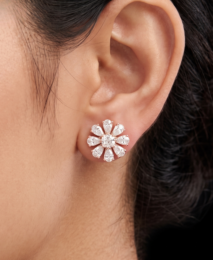Model wearing 4.120 CTW cushion and pear lab-grown diamond floral stud earrings by Kiashaa Jewellery in rose gold.