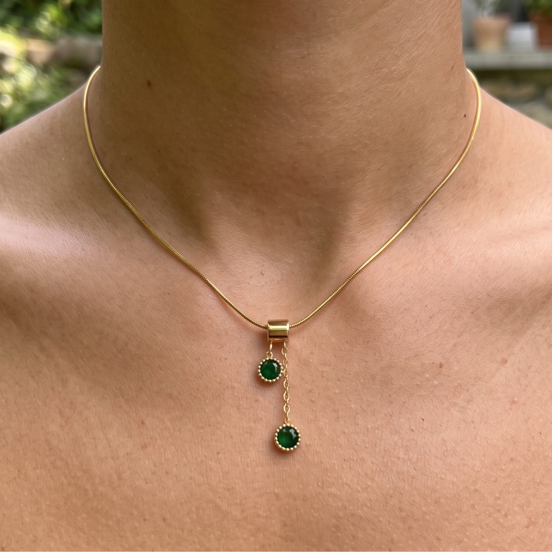  1.50 CTW green round gemstone drop necklace in polished yellow gold.