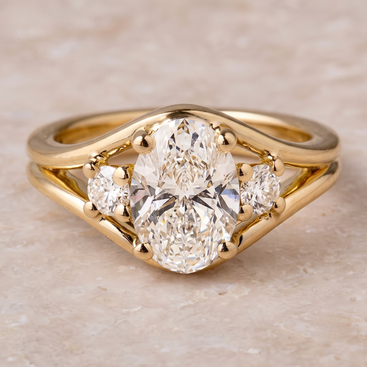 2.39 CT oval and round three-stone diamond engagement ring in yellow gold