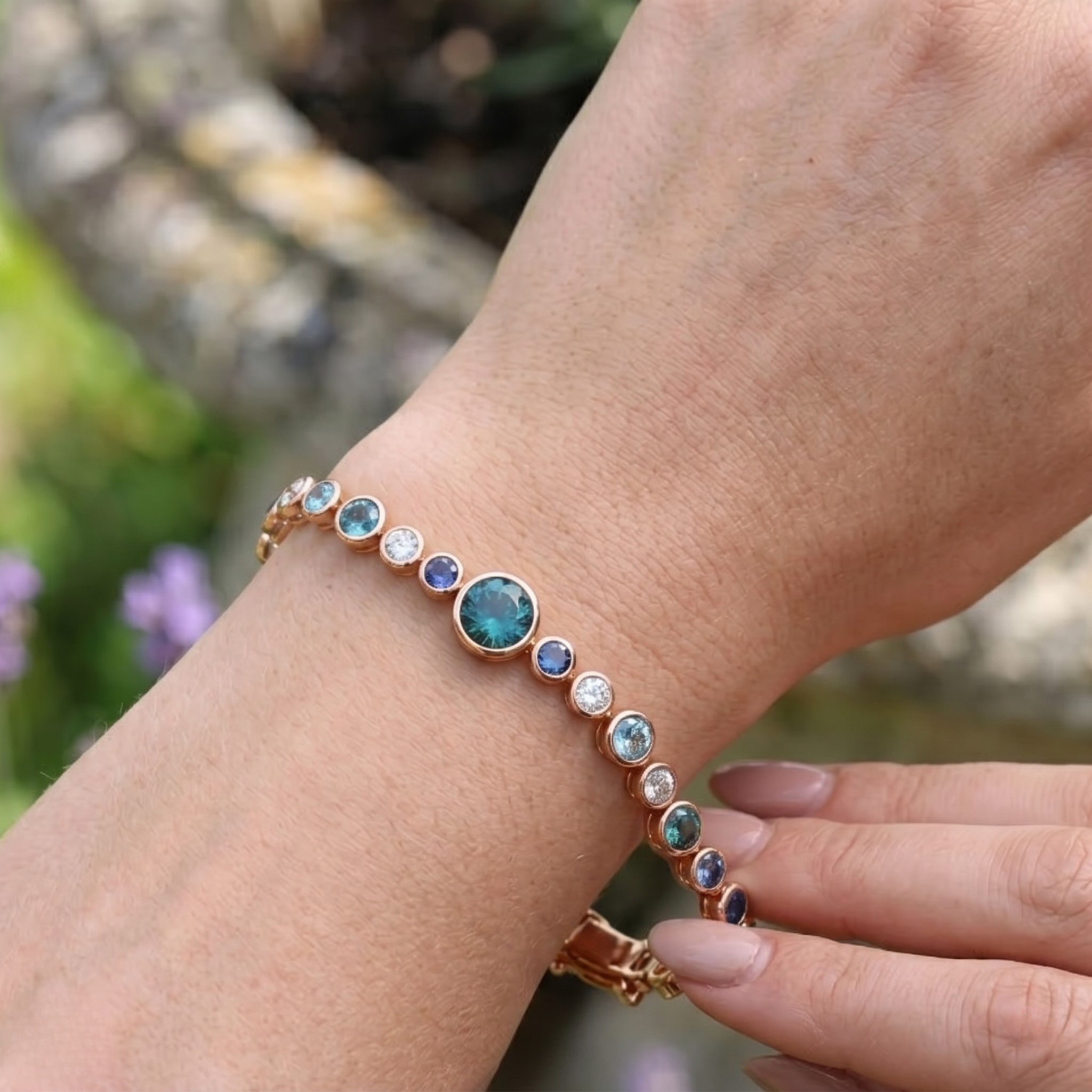 Rainbow bracelet featuring a continuous row of vibrant round gemstones.