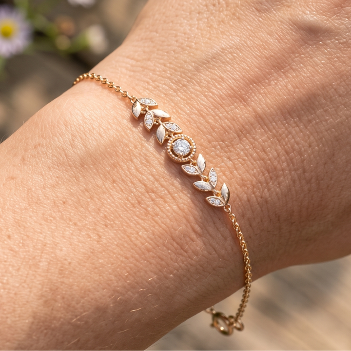 Botanical diamond bracelet featuring a 5.10 mm round center stone with leaf motifs.