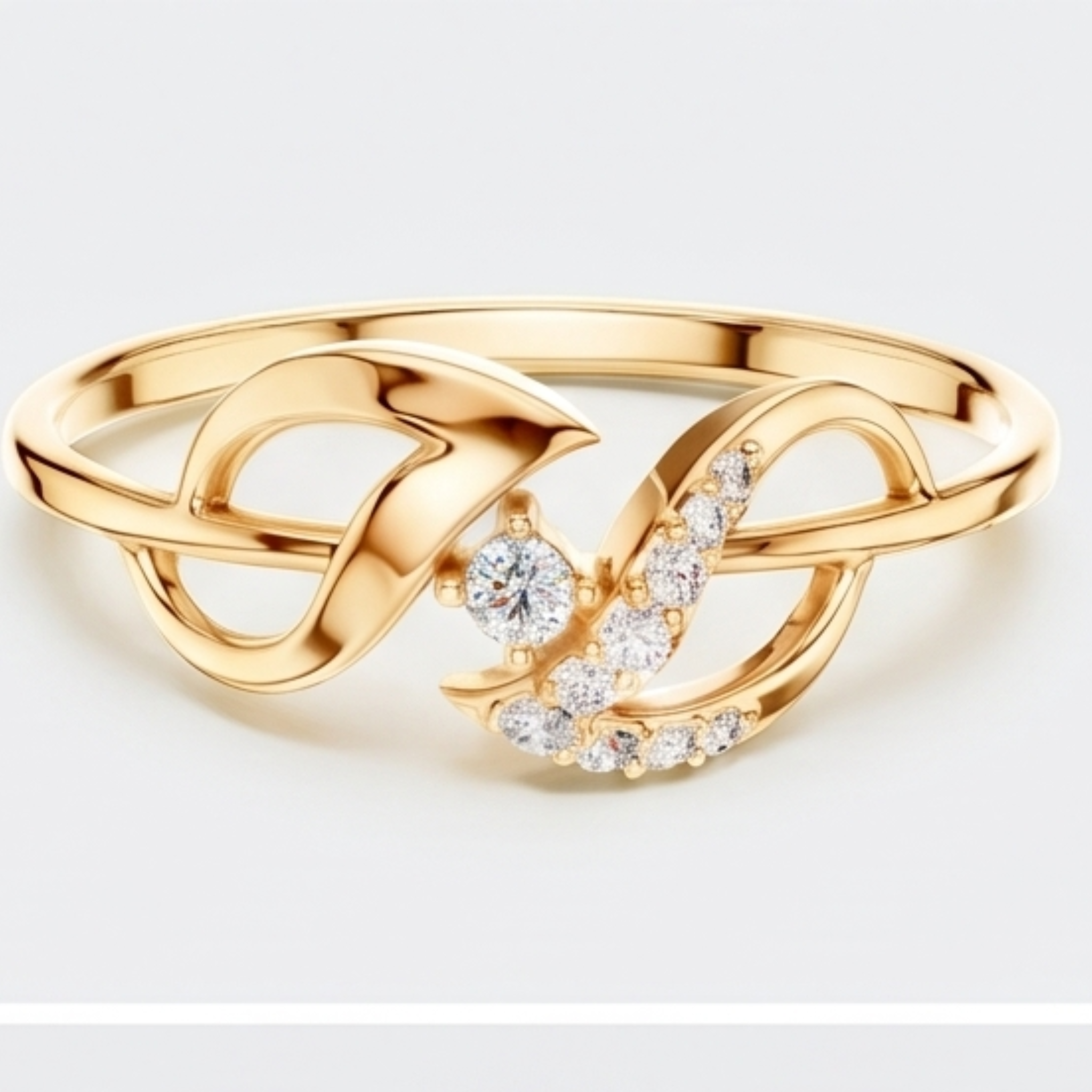 A gold ring featuring a stylized infinity symbol with a central round clear gemstone and a curved row of small clear stones, shown on a light gray background.