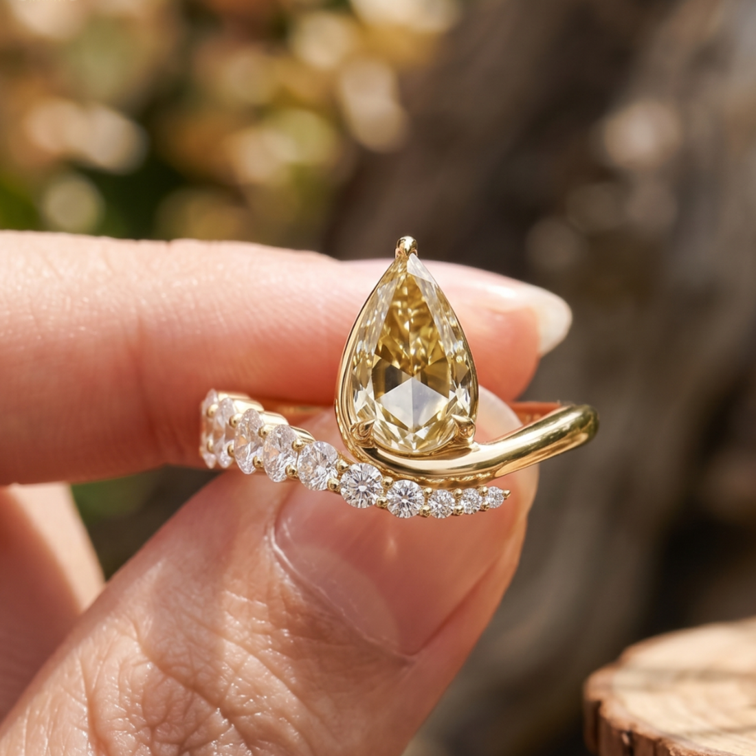 Aurelia 4.50 CTW pear diamond bypass ring by Kiashaa Jewellery featuring a 3 CT pear center diamond in polished yellow gold.