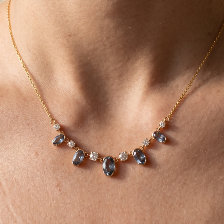 4.20 CTW oval and round diamond station necklace in polished yellow gold.