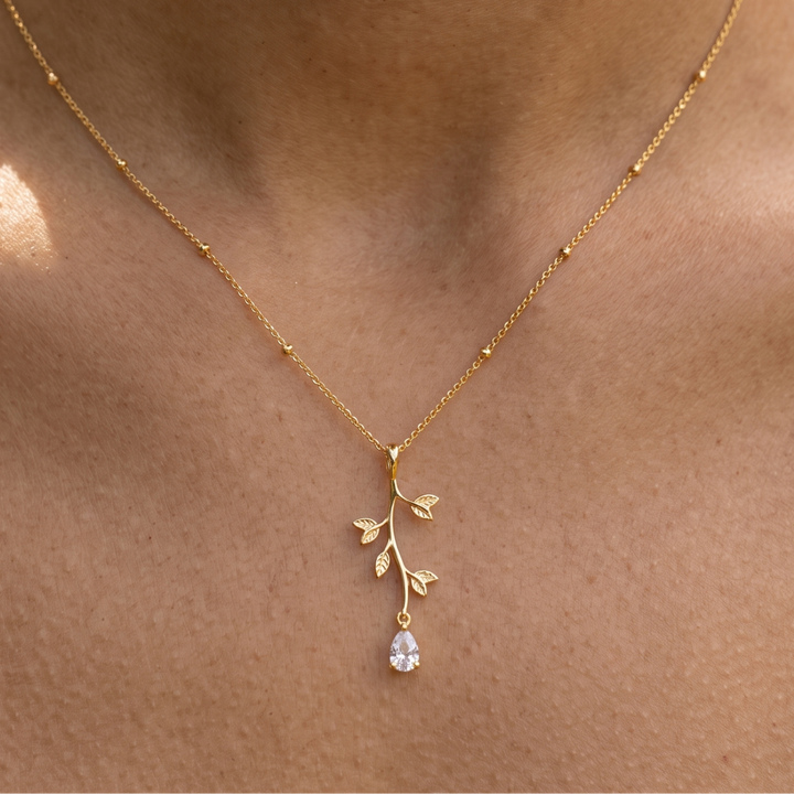 Kiashaa Jewellery 0.39 CT pear diamond leaf pendant necklace in polished yellow gold.