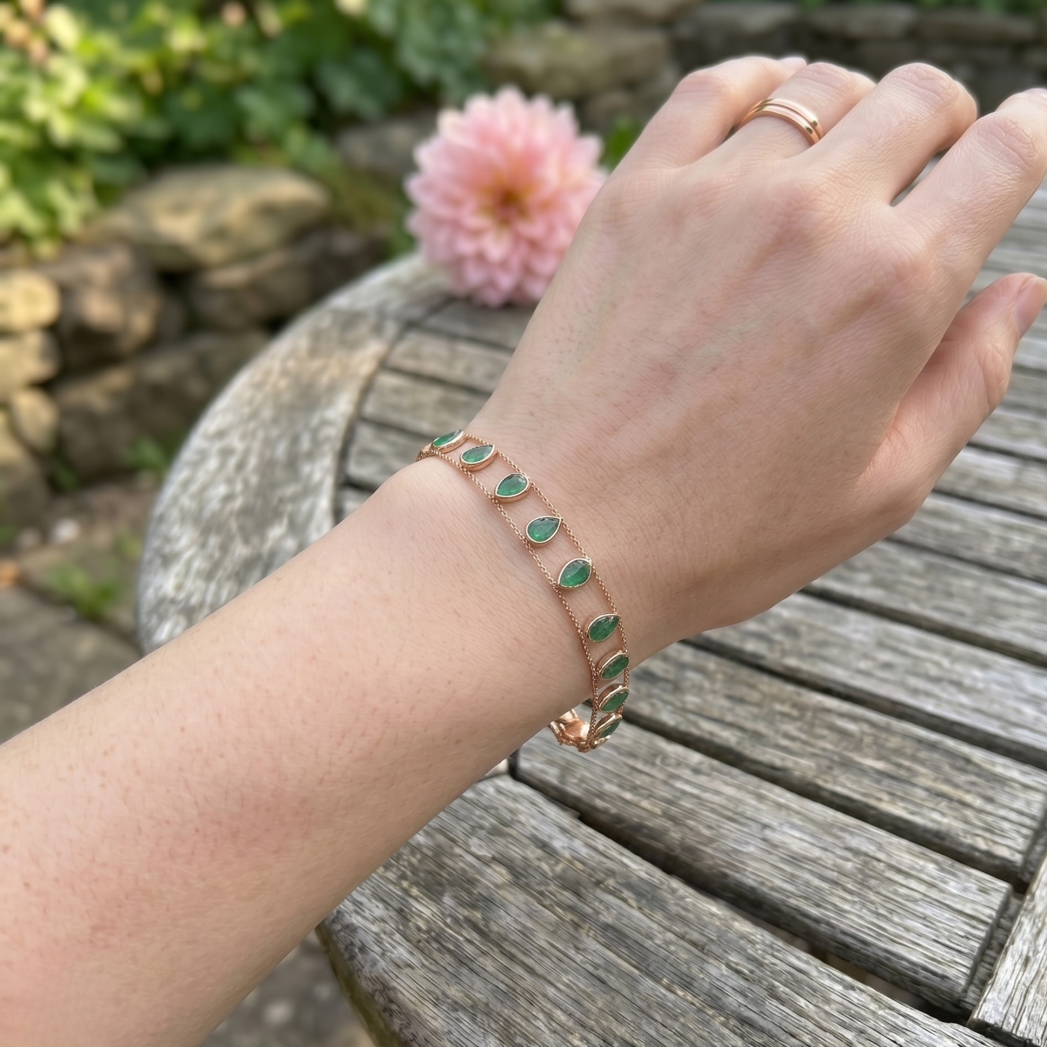 Elegant botanical bracelet with pear and marquise-shaped green crystal stations.