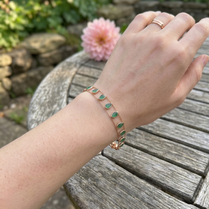 Elegant botanical bracelet with pear and marquise-shaped green crystal stations.