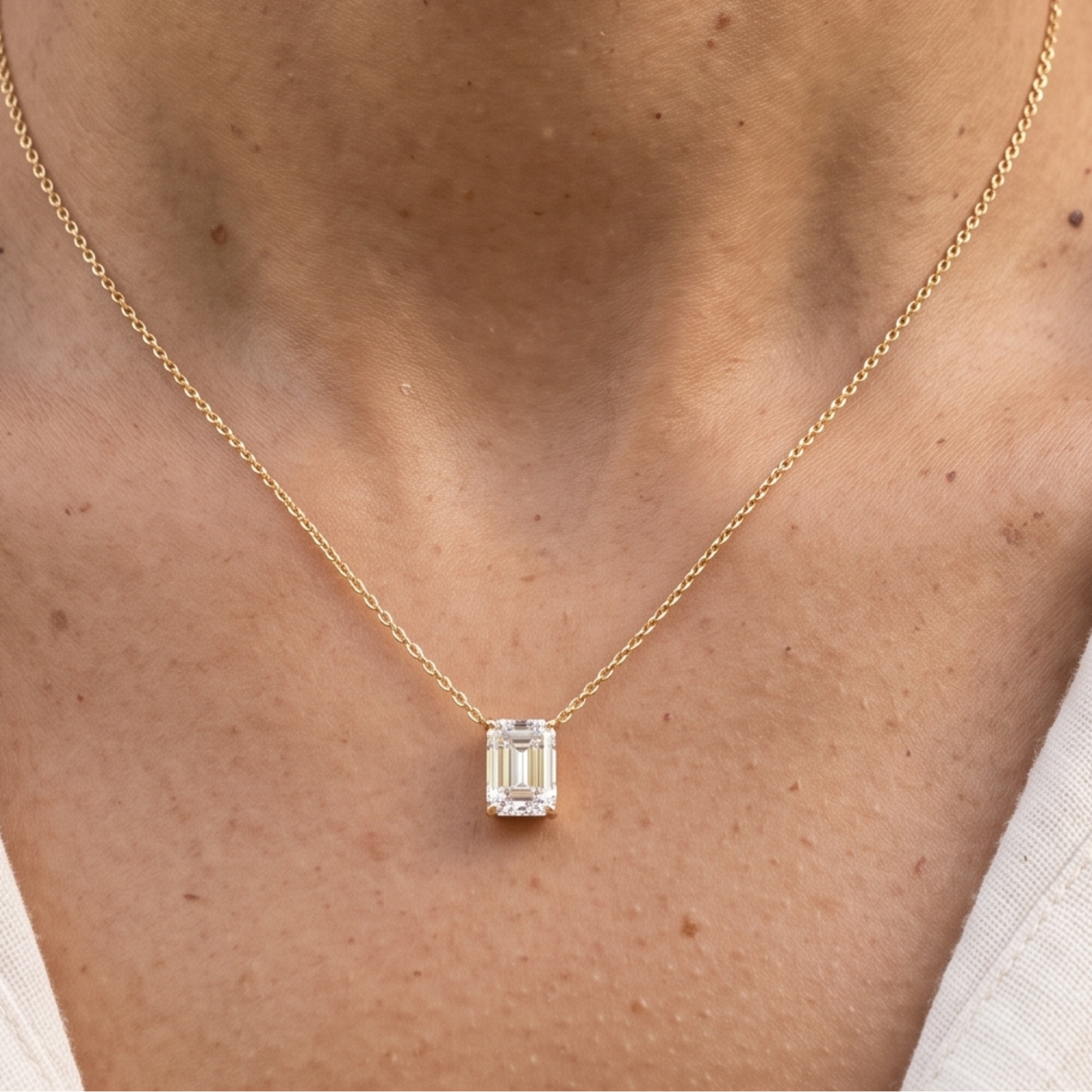 2.58 CT emerald-cut diamond solitaire pendant necklace in polished yellow gold.