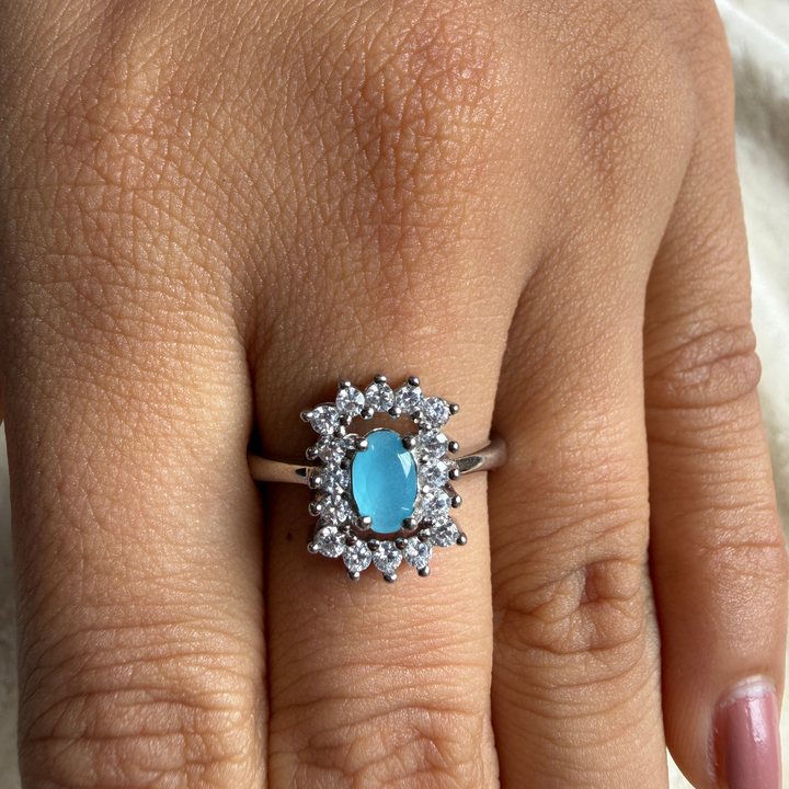 Sky blue oval gemstone and lab-grown diamond halo ring by Kiashaa Jewellery.