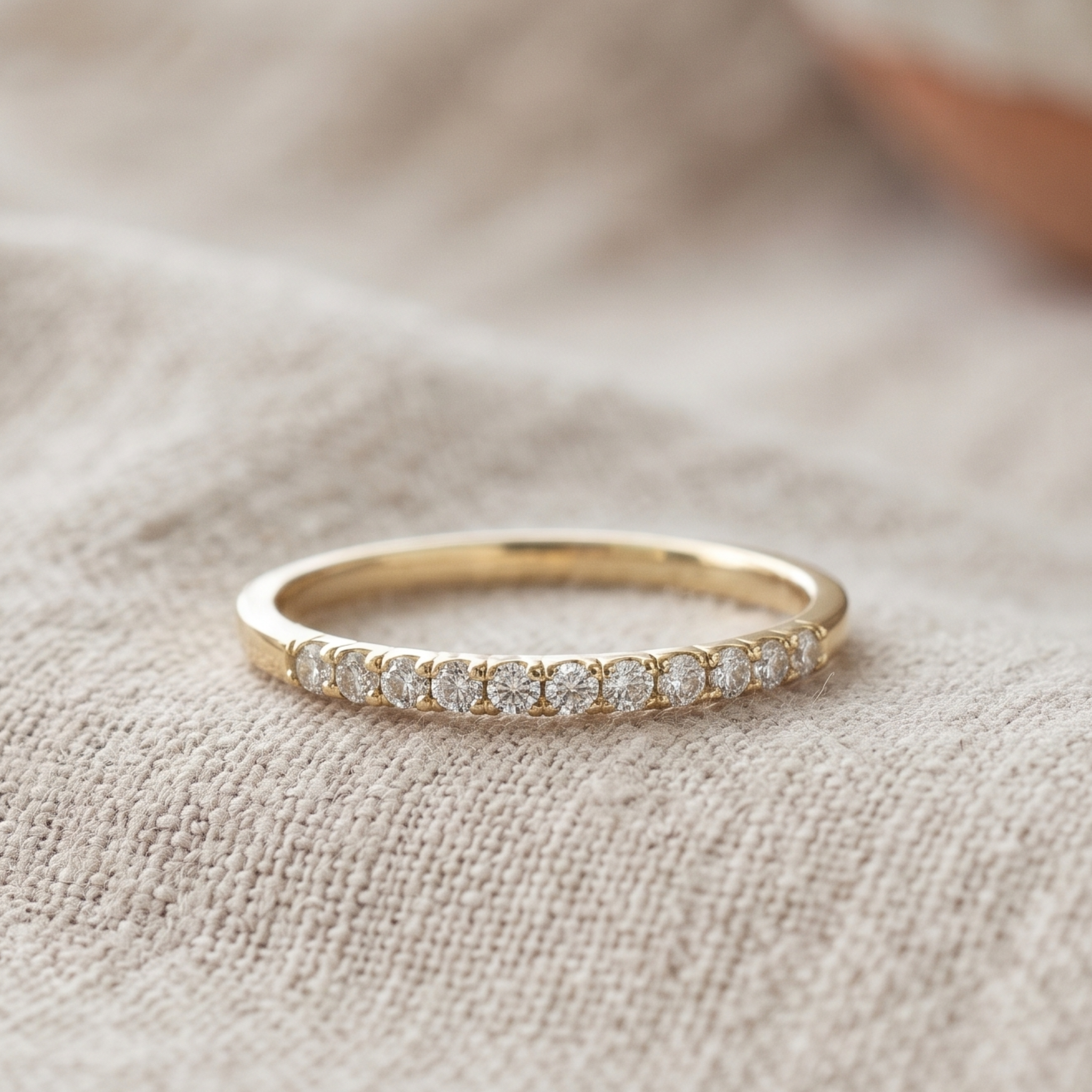 Front view of a 0.77 CTW round diamond half-eternity wedding band in yellow gold.
