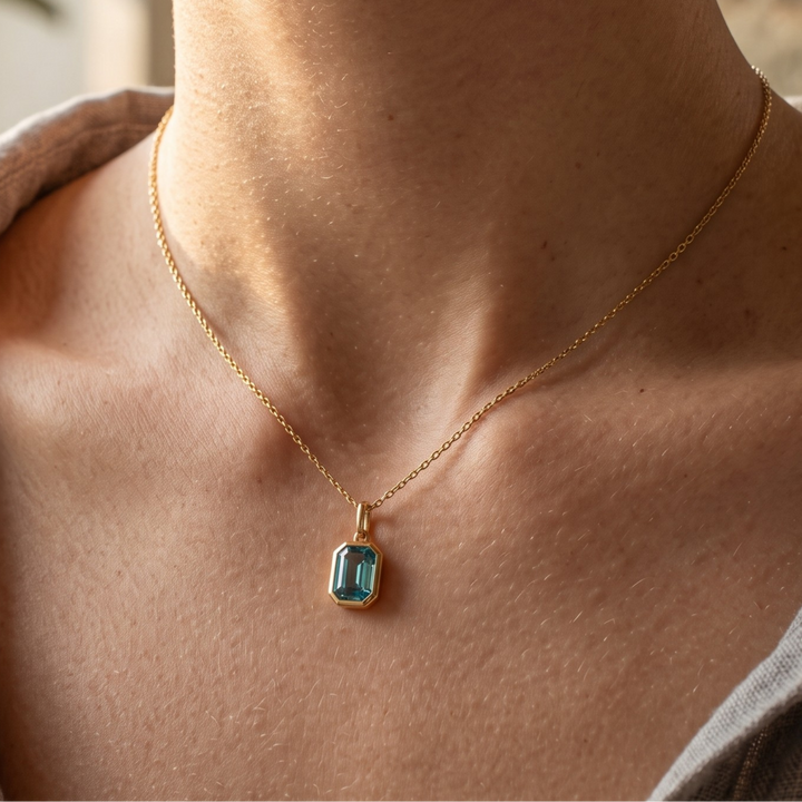 1.73 CT teal emerald-cut pendant necklace in polished yellow gold.
