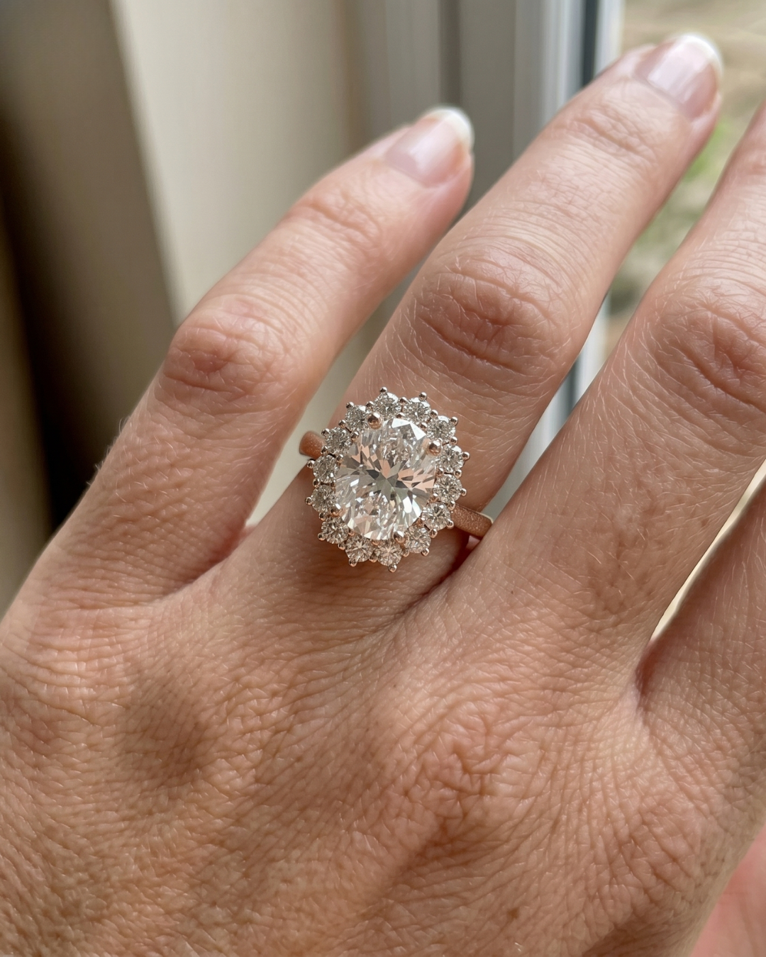 2.560 CT oval lab-grown diamond halo ring by Kiashaa Jewellery in rose gold with brilliant round diamond accents.