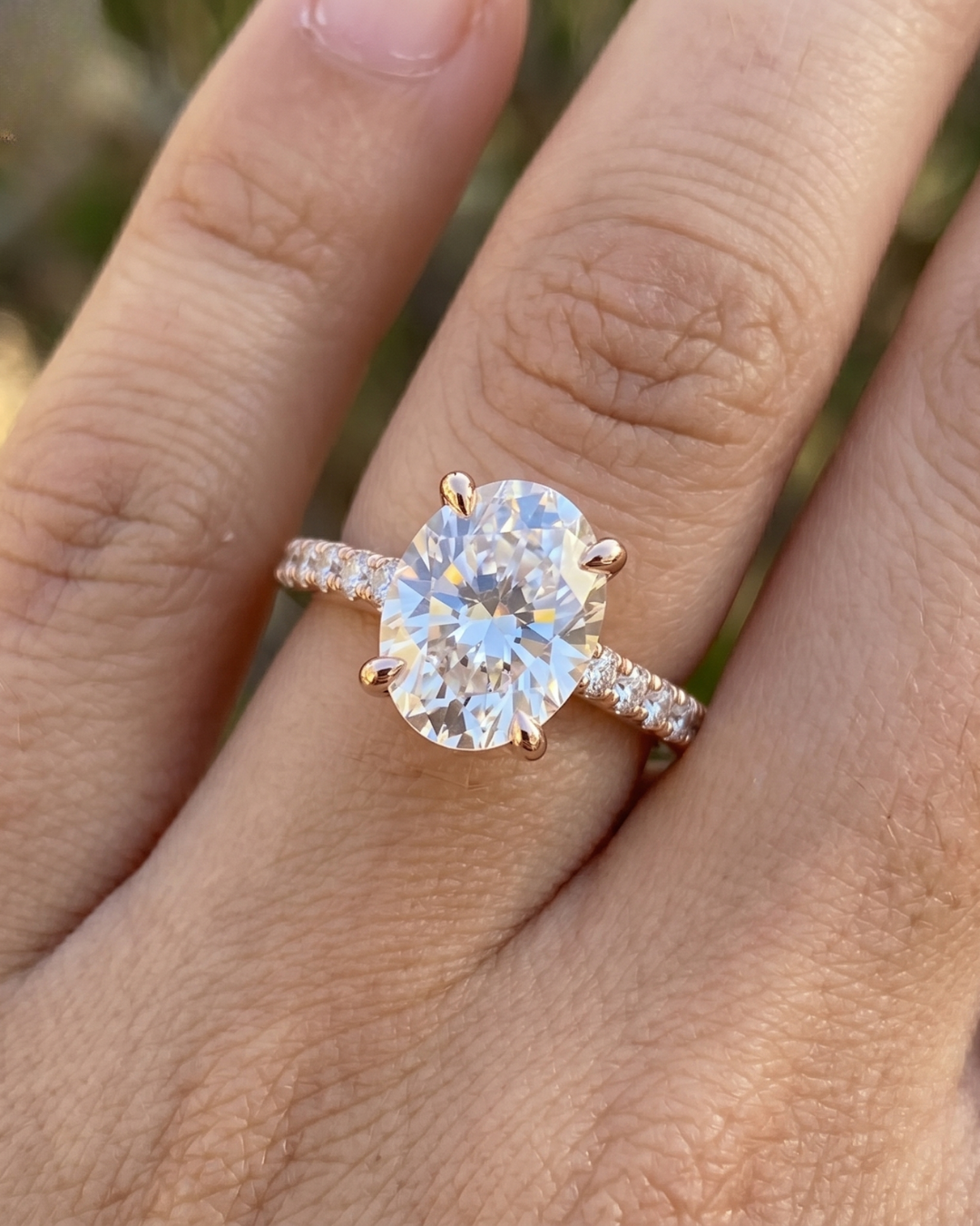 2.304 carat oval lab-grown diamond ring by Kiashaa Jewellery in rose gold with round diamond band accents.