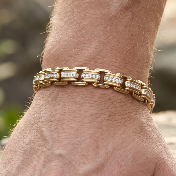 A close-up of a gold link bracelet with rows of clear pavé stones worn on a person's wrist.