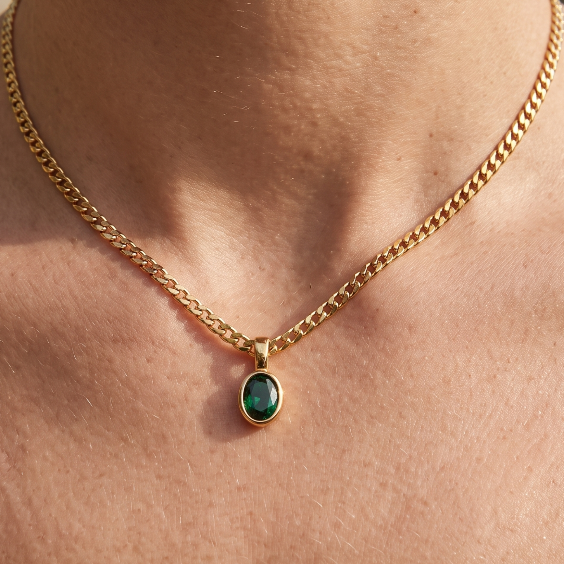 1.98 CT green oval gemstone pendant necklace with polished yellow gold Cuban chain.