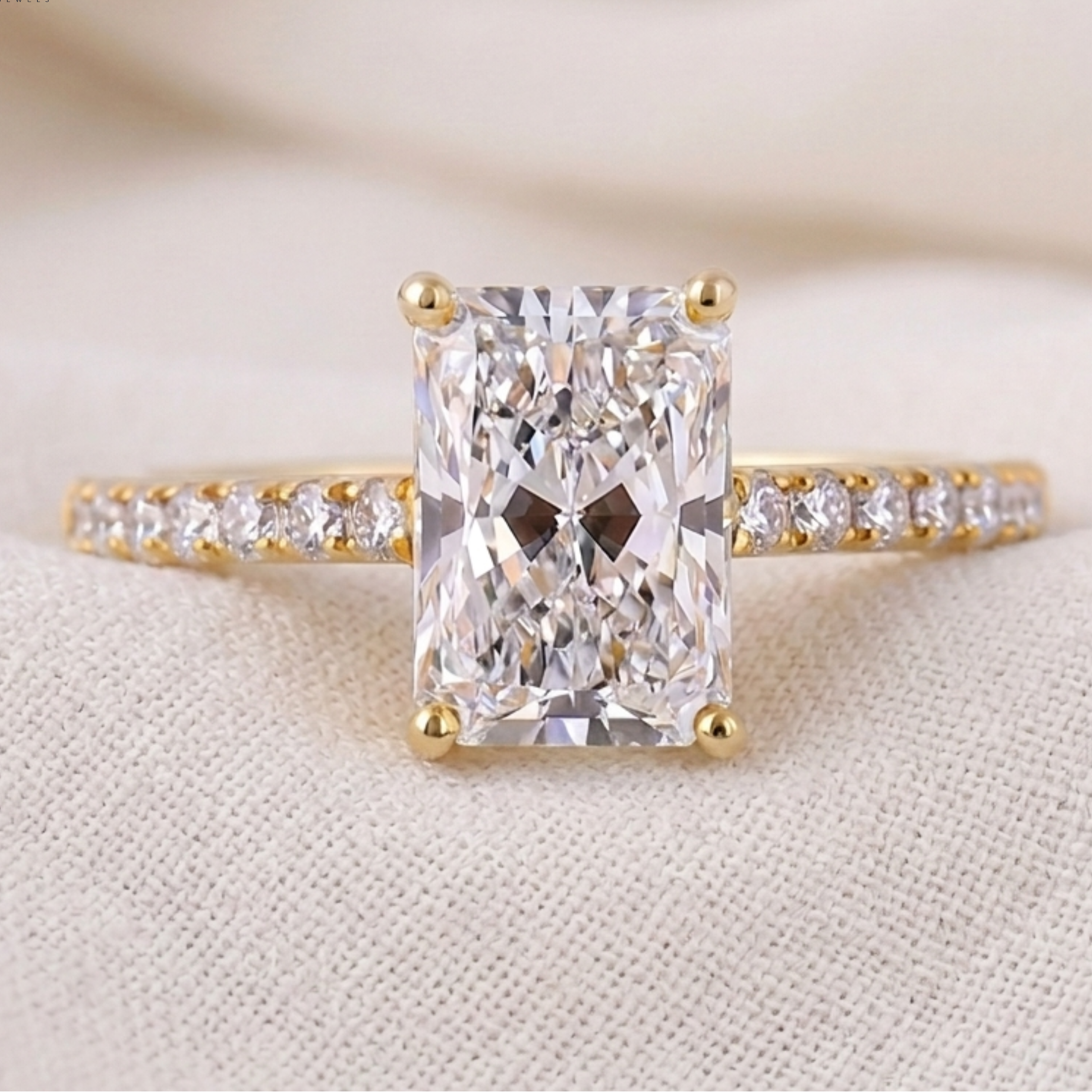 Emerald-cut solitaire proposal ring with 16 round diamond accents