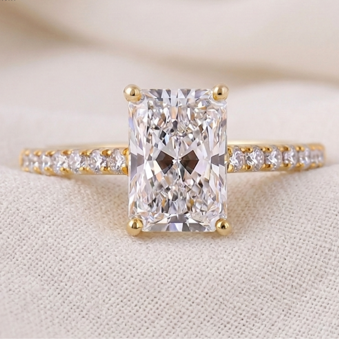 Emerald-cut solitaire proposal ring with 16 round diamond accents
