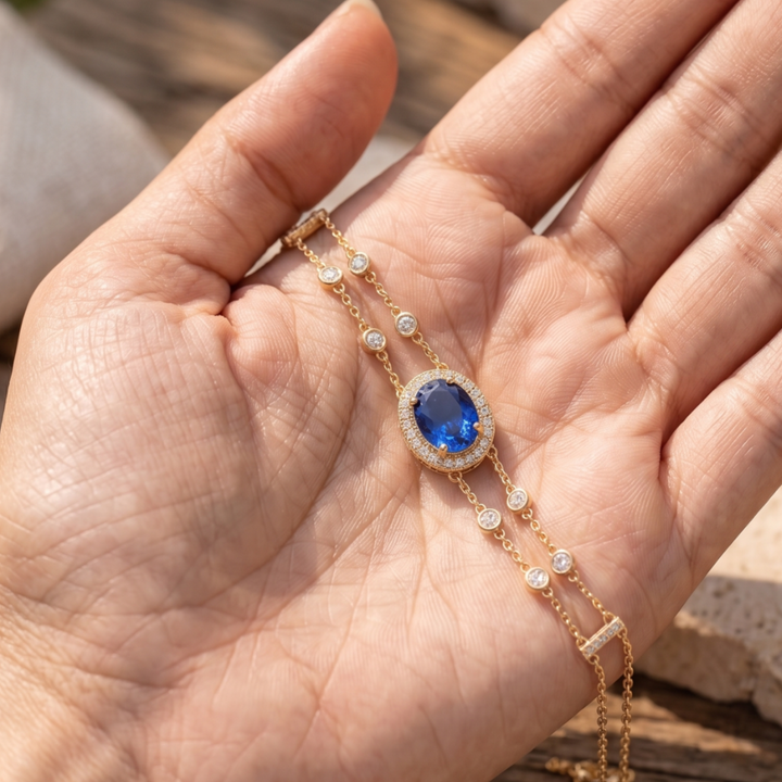 2 CT oval blue sapphire bracelet with diamond halo in yellow gold by Kiashaa Jewellery.