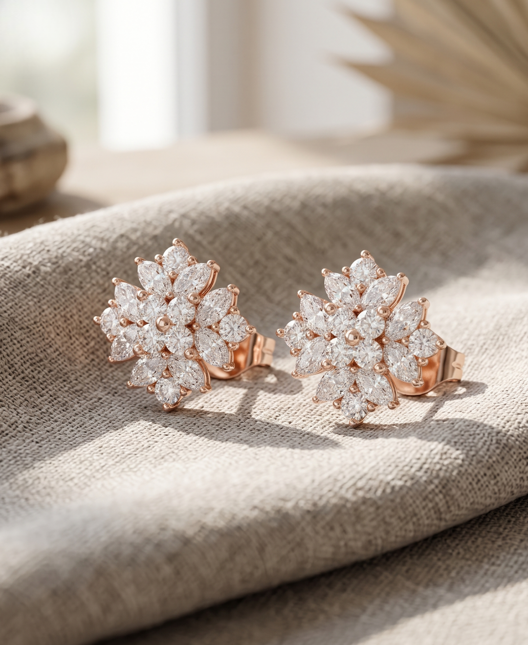 Front and side view of marquise and round diamond flower earrings with polished rose gold prong settings.