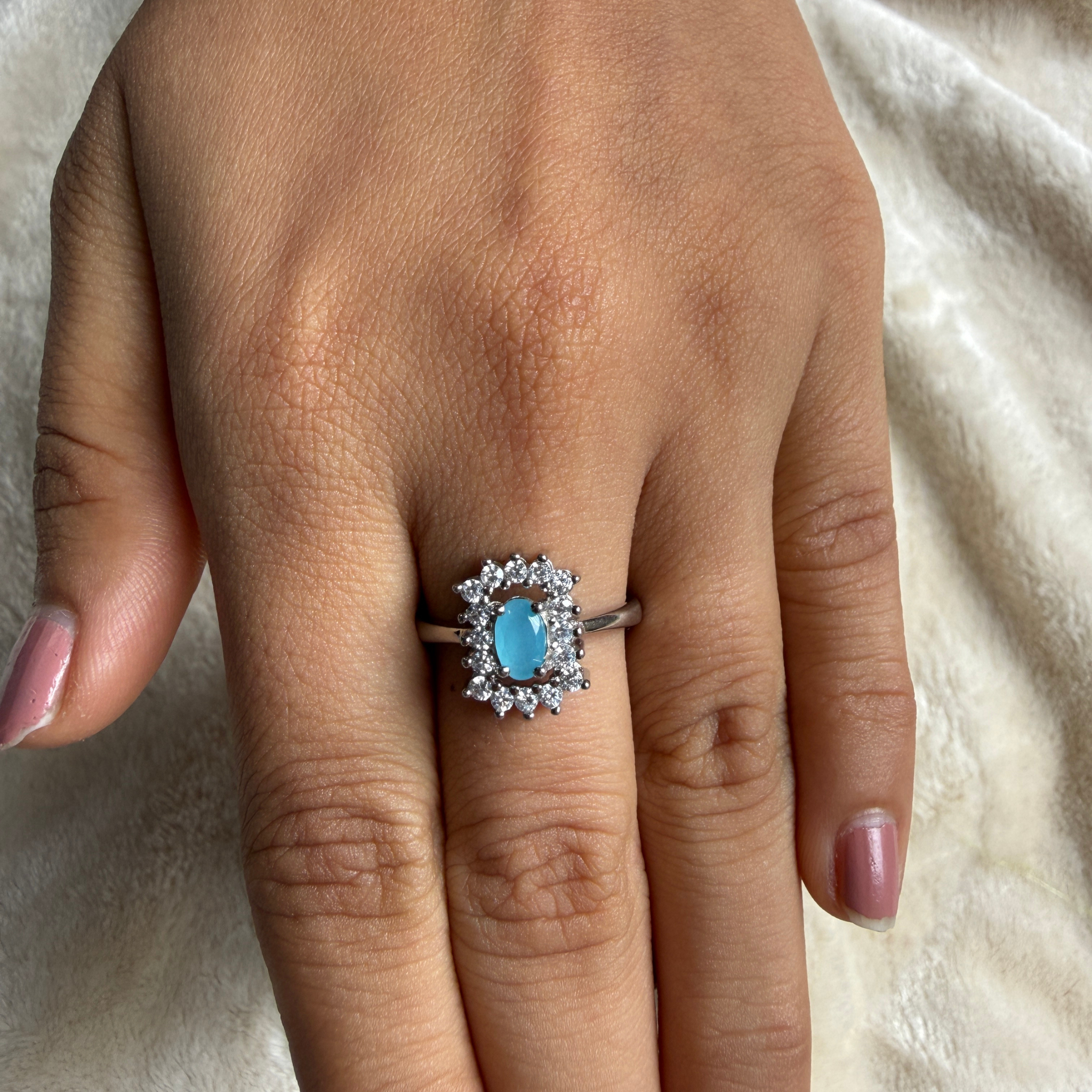 Sky blue oval gemstone and lab-grown diamond halo ring by Kiashaa Jewellery.