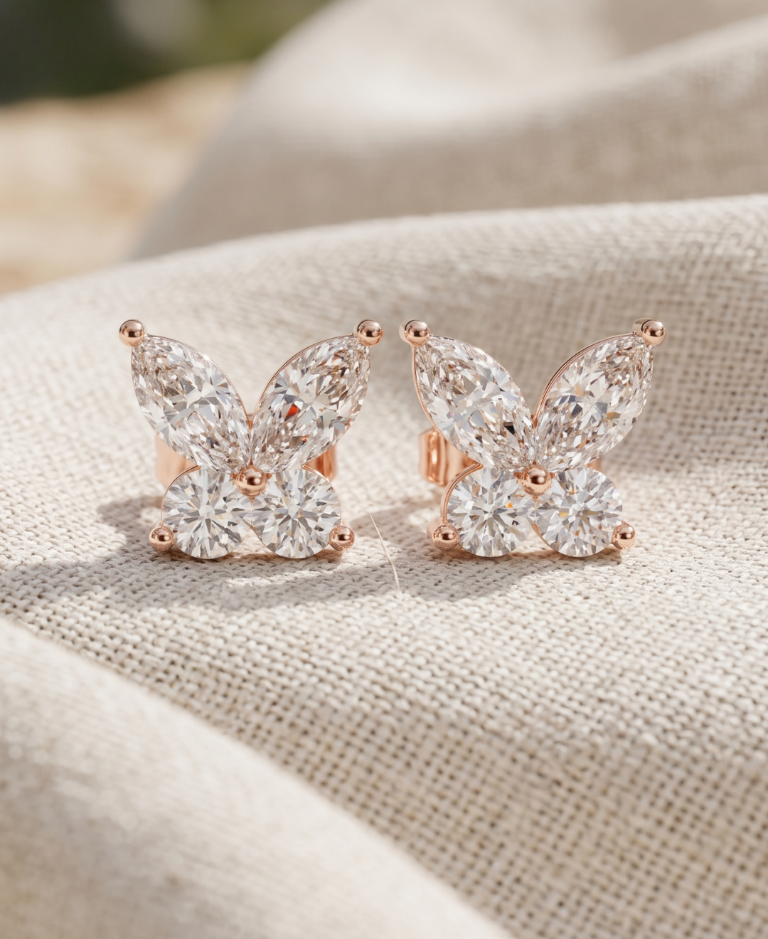 Butterfly-shaped lab-grown diamond stud earrings featuring marquise and round diamonds in rose gold.