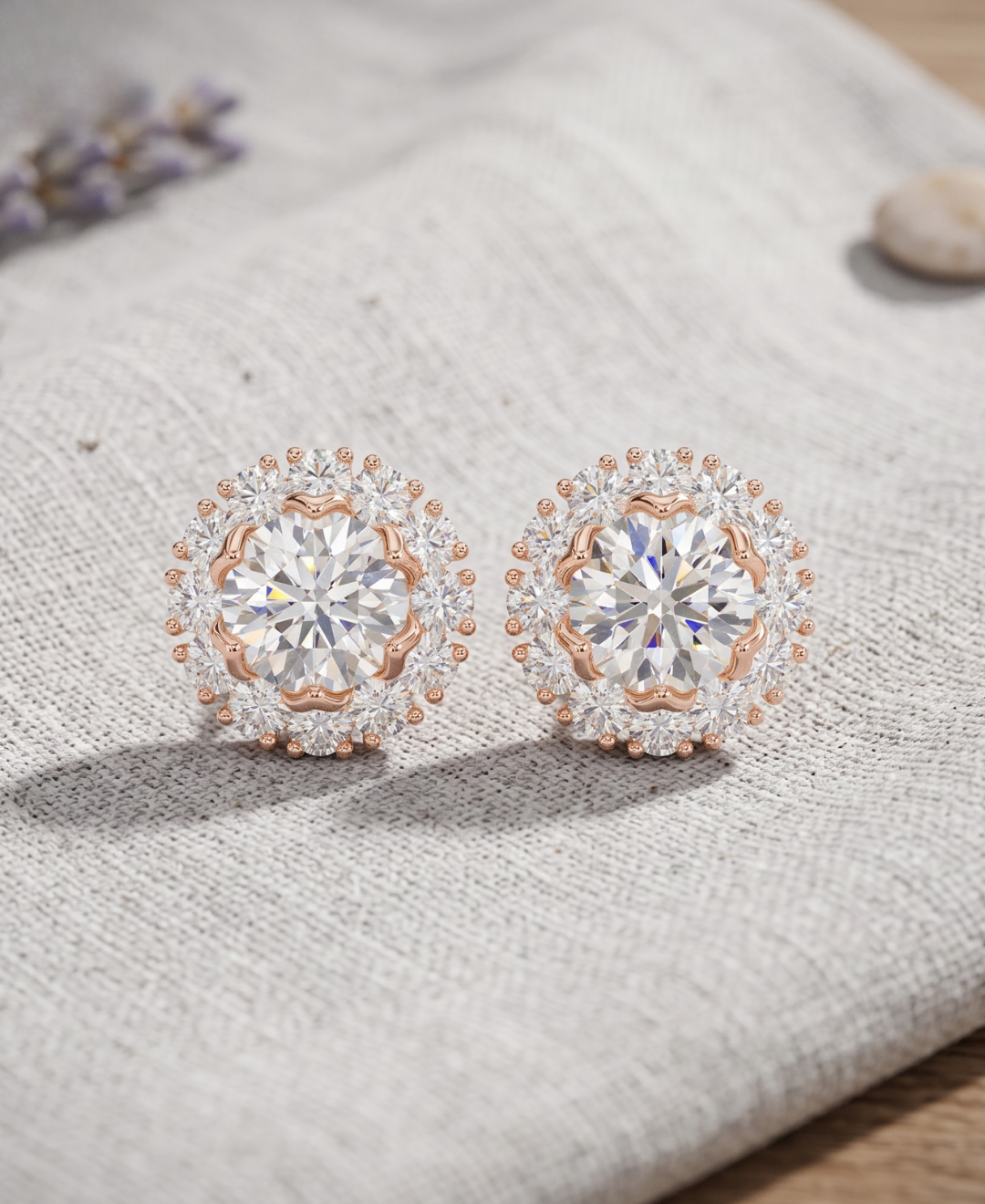 Round brilliant lab-grown diamond halo earrings featuring a sparkling centre stone in rose gold.
