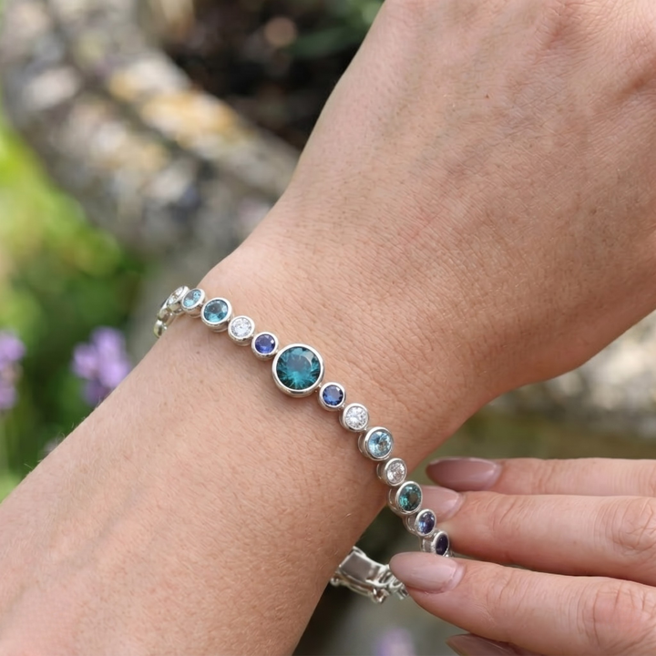 Rainbow bracelet featuring a continuous row of vibrant round gemstones.
