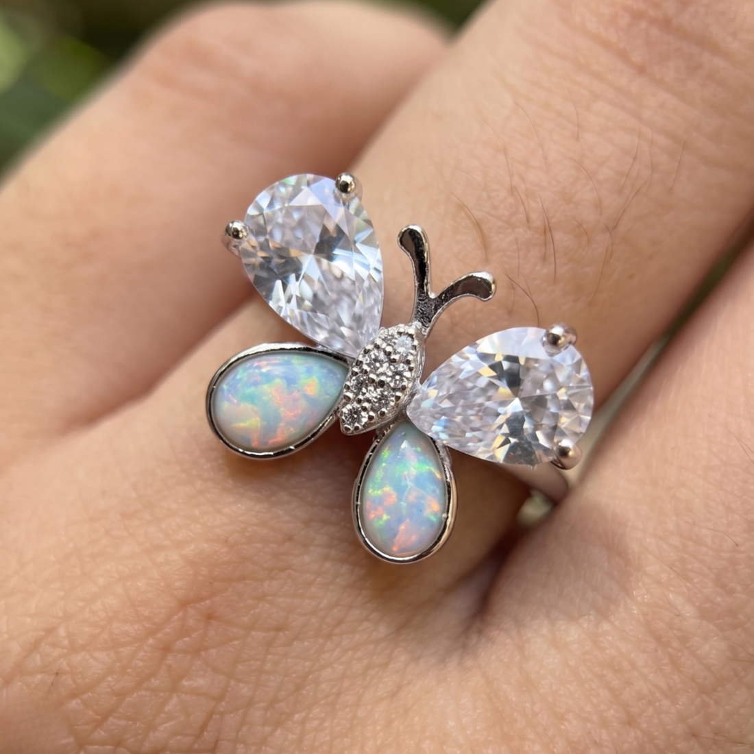 Nature-inspired butterfly ring featuring pear-shaped lab-grown diamonds and opal gemstones.