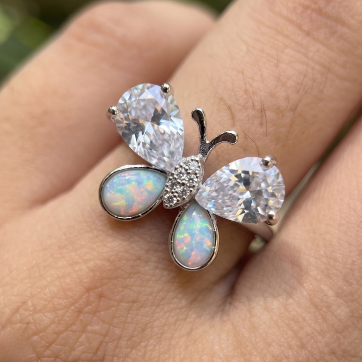 Nature-inspired butterfly ring featuring pear-shaped lab-grown diamonds and opal gemstones.
