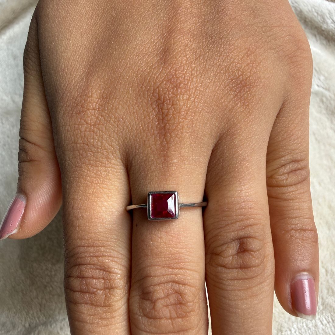 Red princess-cut gemstone solitaire ring in white gold by Kiashaa Jewellery.