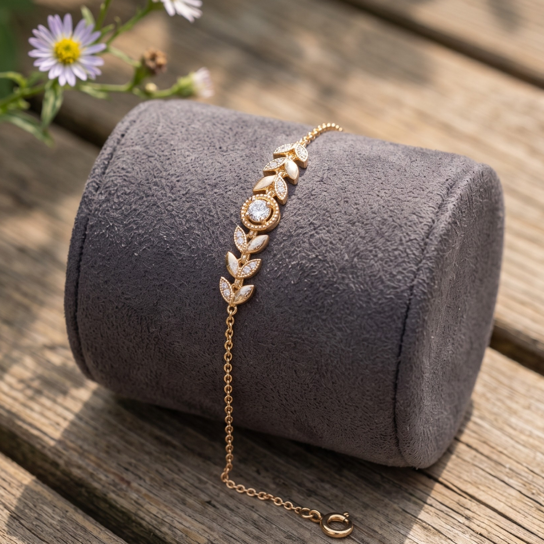 Botanical diamond bracelet featuring a 5.10 mm round center stone with leaf motifs.