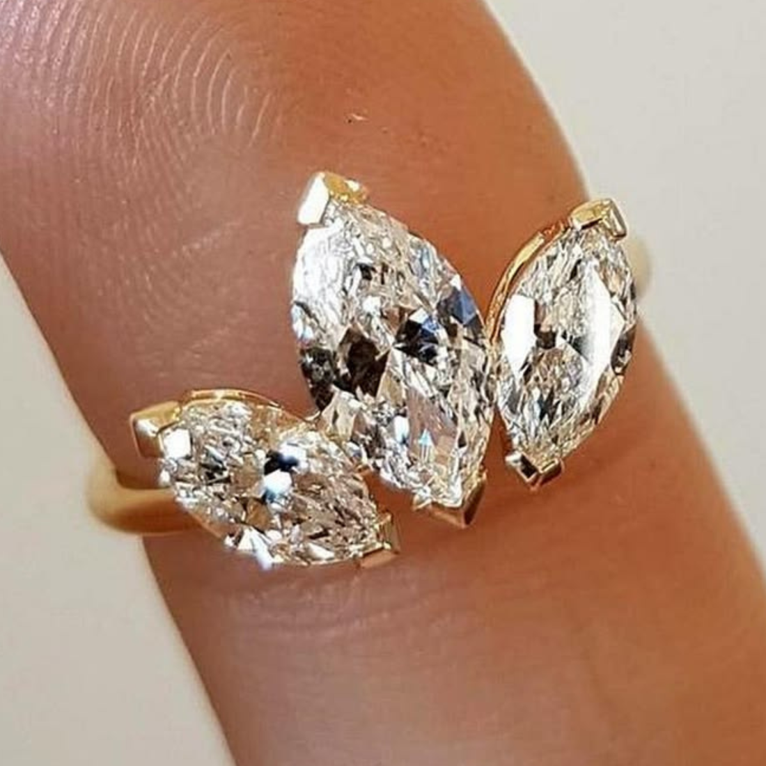 Luxury 1.72 CTW ring featuring three graduated marquise-cut diamonds.