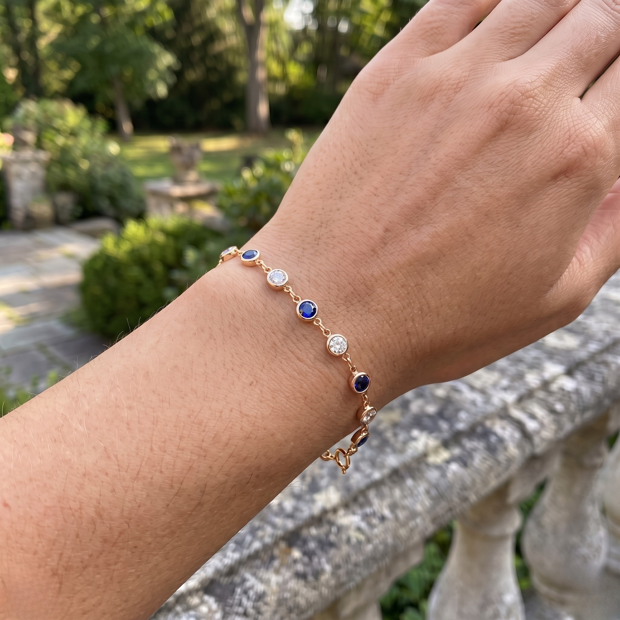 Luxury tennis bracelet with round blue gemstones and brilliant white diamonds.