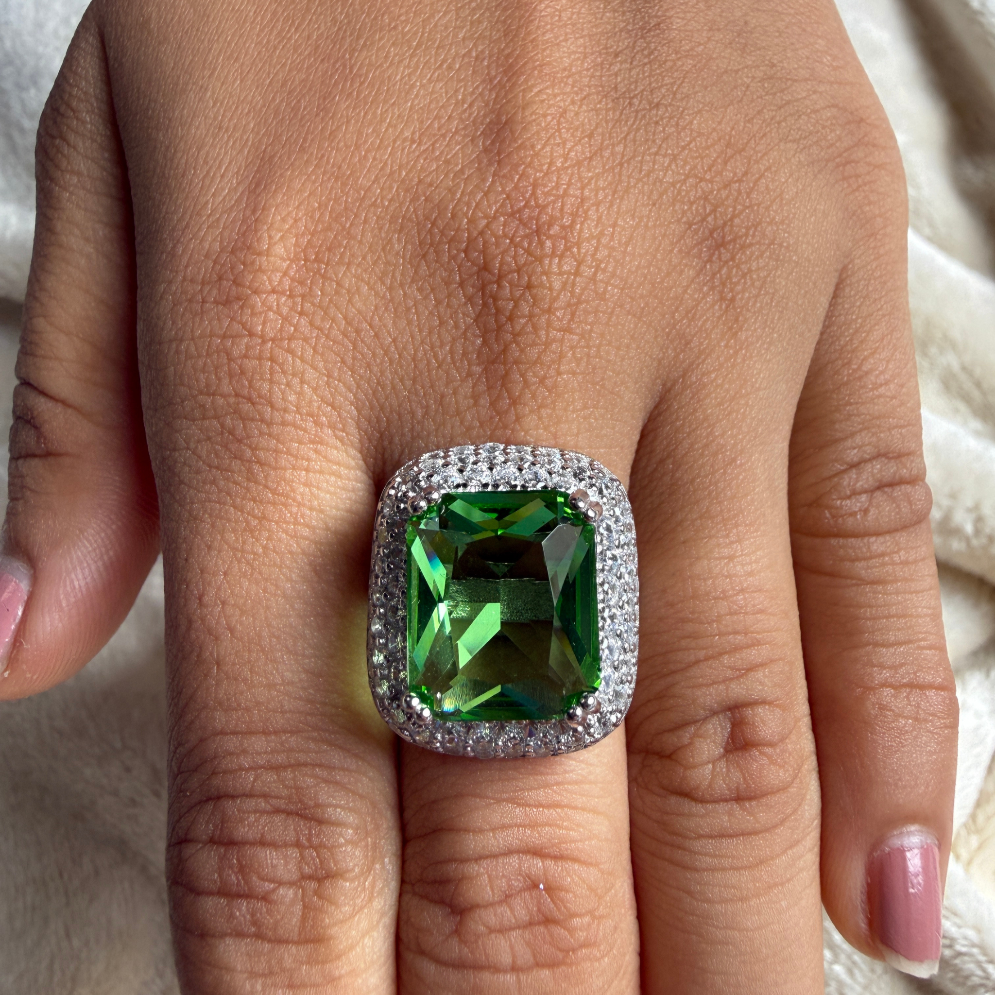Green emerald-cut gemstone and lab-grown diamond double halo ring by Kiashaa Jewellery.