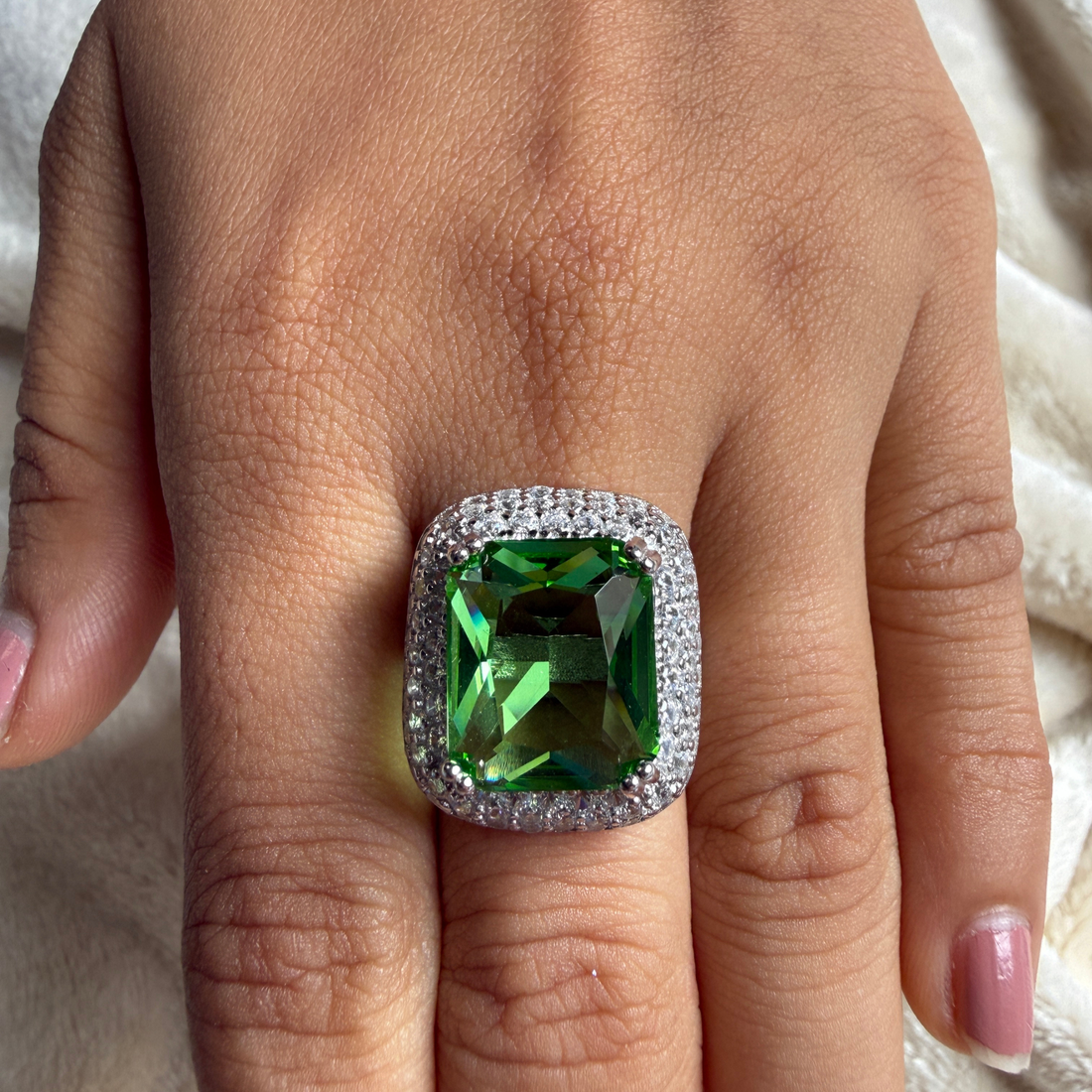 Green emerald-cut gemstone and lab-grown diamond double halo ring by Kiashaa Jewellery.