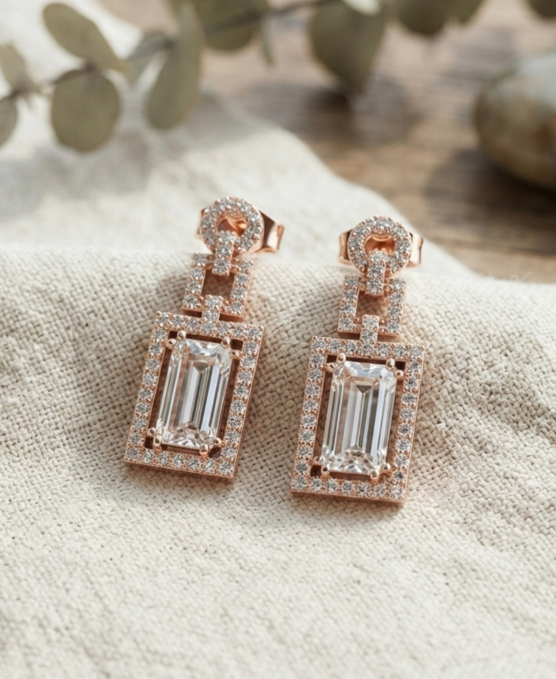 Rose gold geometric diamond earrings featuring rectangular baguette centres and round diamond pavé frames.