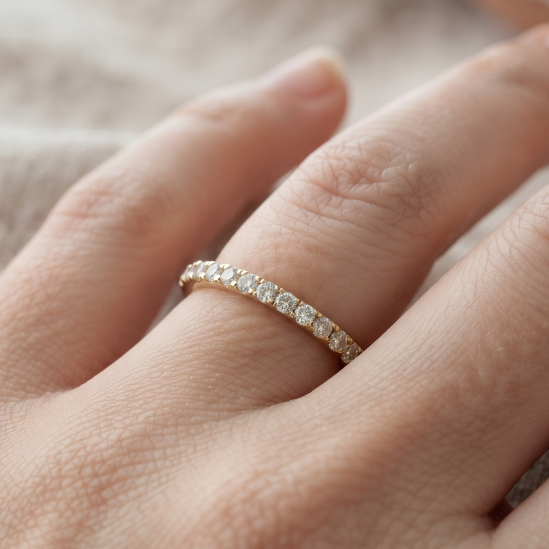 Front view of a 0.77 CTW round diamond half-eternity wedding band in yellow gold.